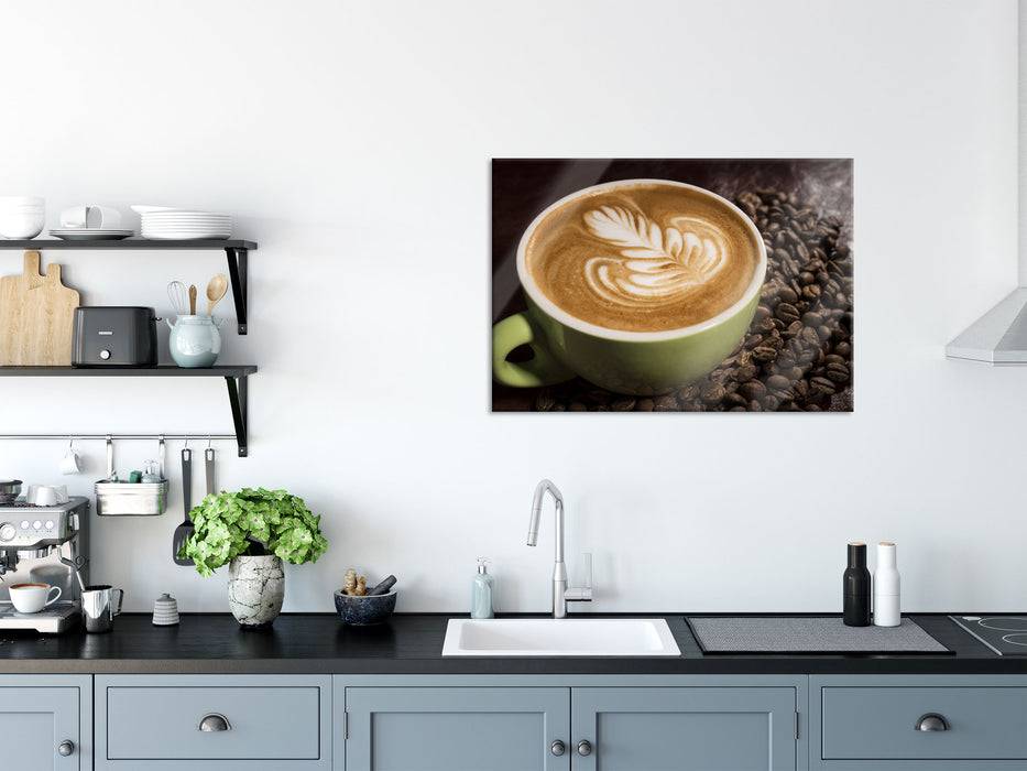 Pixxprint Cappucino zwischen Kaffeebohnen, Glasbild Rabatte dieses Monats